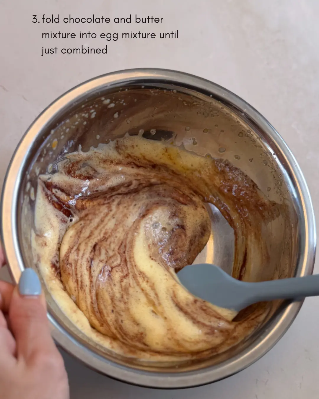Combining melted chocolate with egg mixture for lava cake