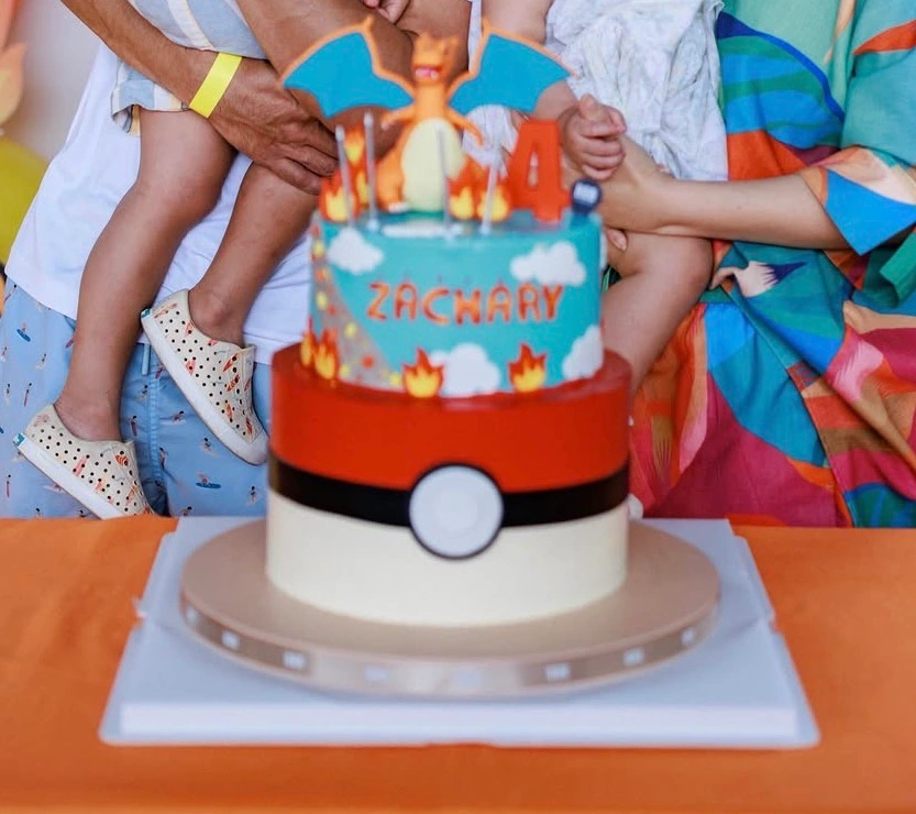 Two-tier Pokemon Charizard birthday cake displayed at a children's birthday celebration in Singapore