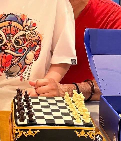 Finished customised chess birthday cake being presented at a family birthday celebration