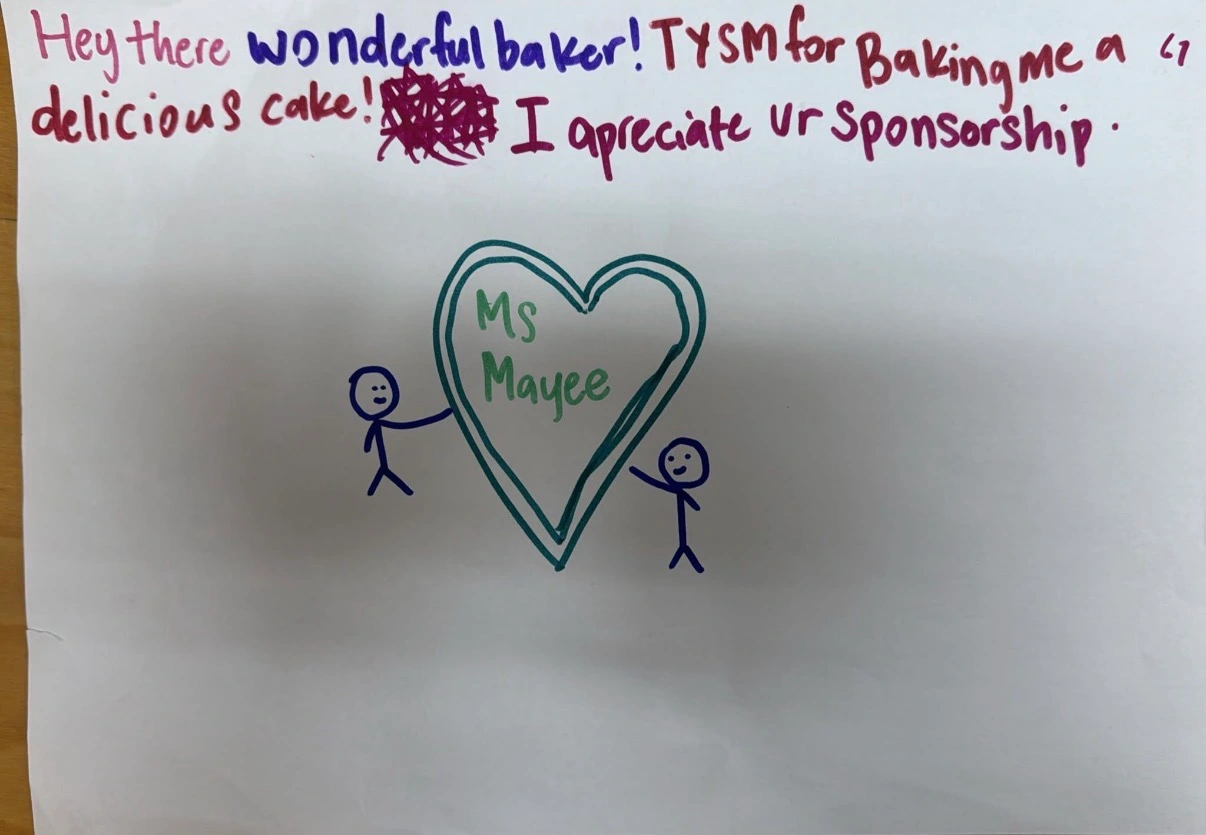Handwritten thank-you drawing from a child for a sponsored birthday cake
