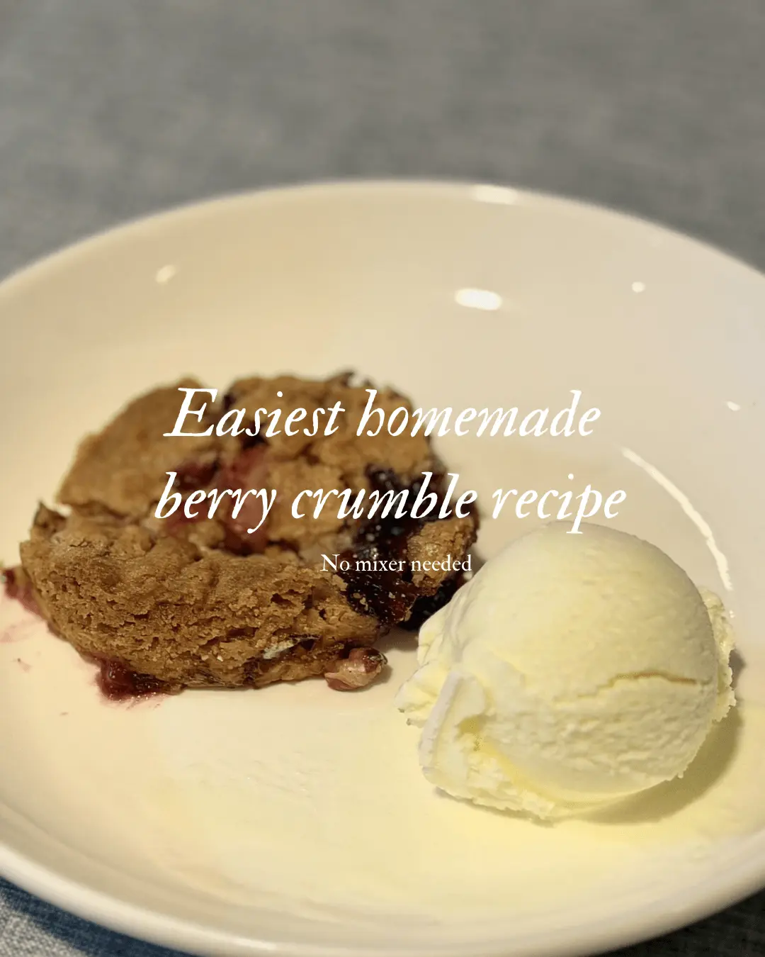 Homemade berry crumble served warm with golden crumble topping