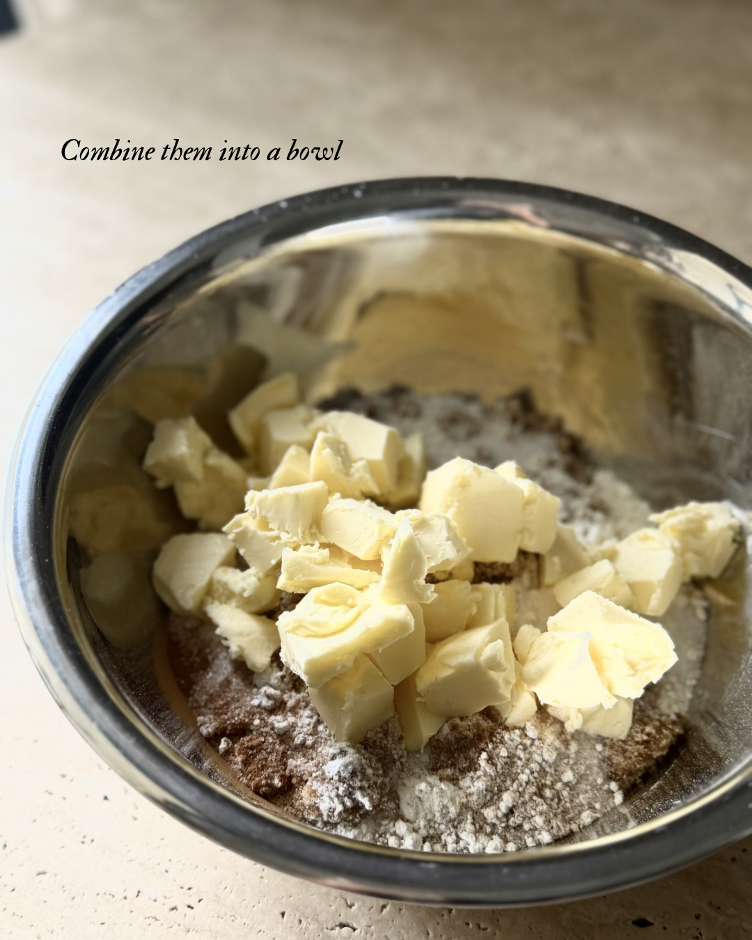 Cubed cold butter added to flour and sugar mixture for homemade berry crumble