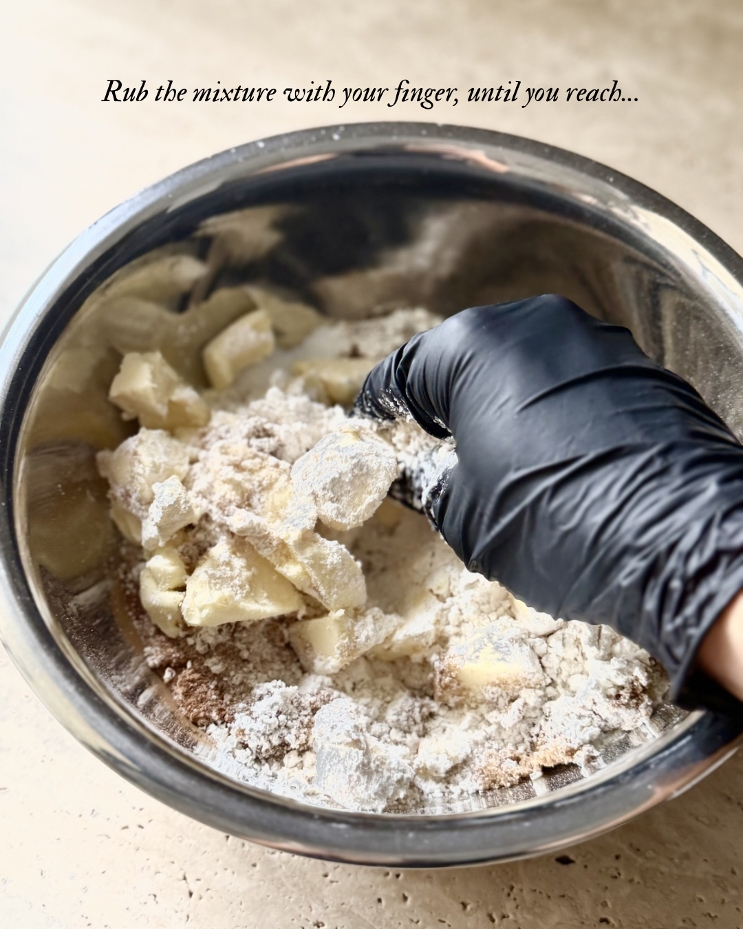 Rubbing cold butter into flour and sugar mixture for berry crumble topping