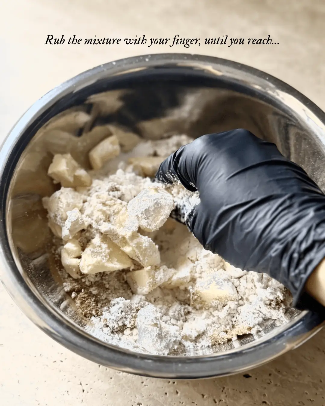 Rubbing cold butter into flour and sugar mixture for berry crumble topping