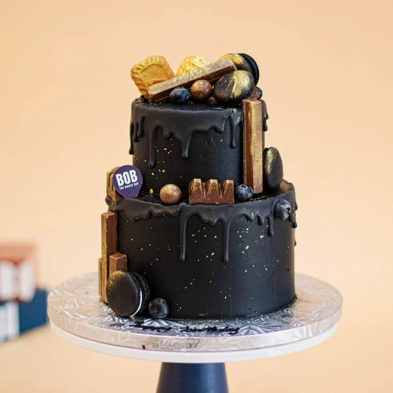 Candy Topped Black and Gold Cake