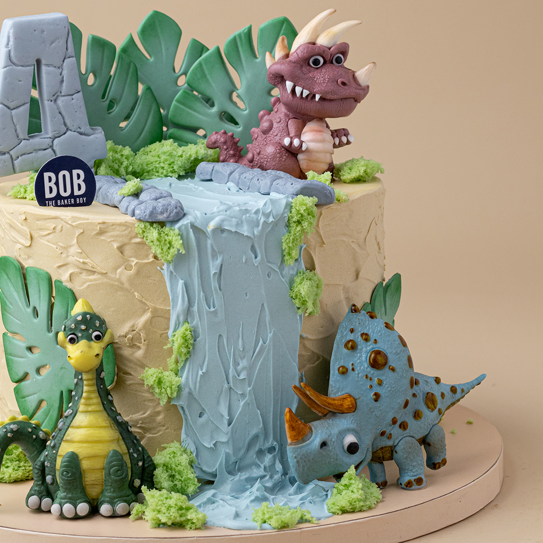 Cute Dinosaurs on Waterfall with Monstera Leaves Cake