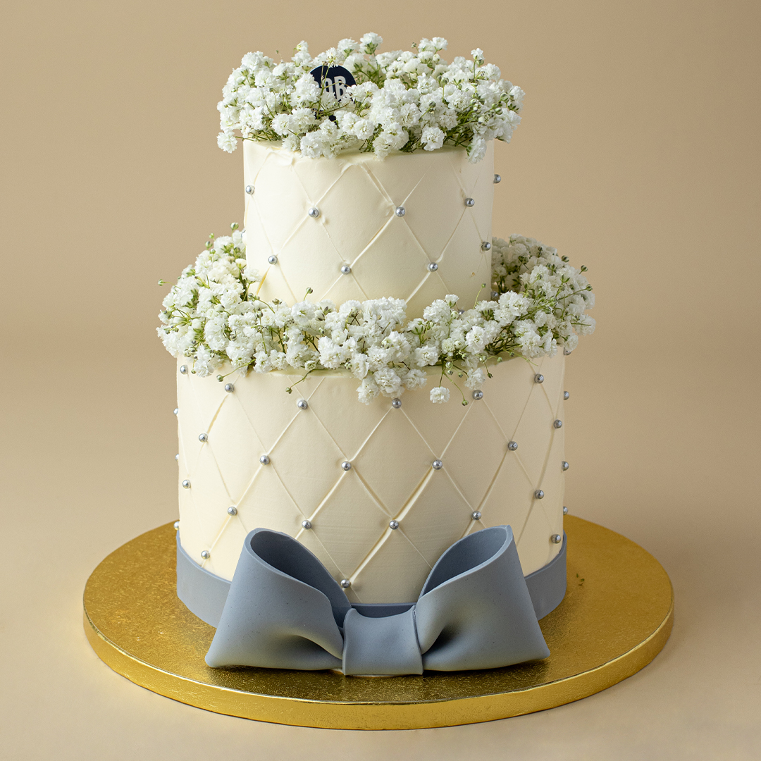 Dusty White Cake with Babies Breath and Satin Ribbon