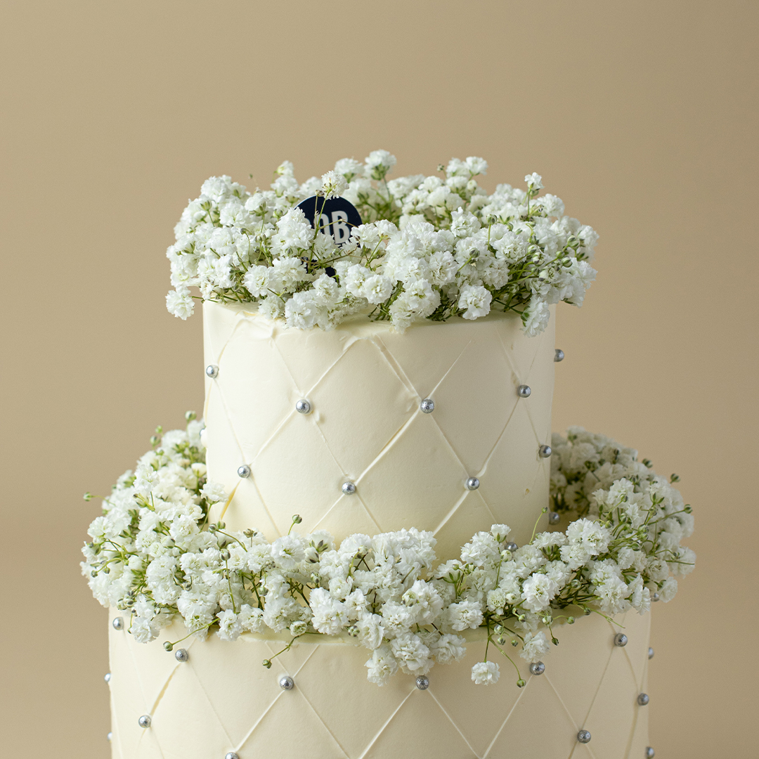 Dusty White Cake with Babies Breath and Satin Ribbon