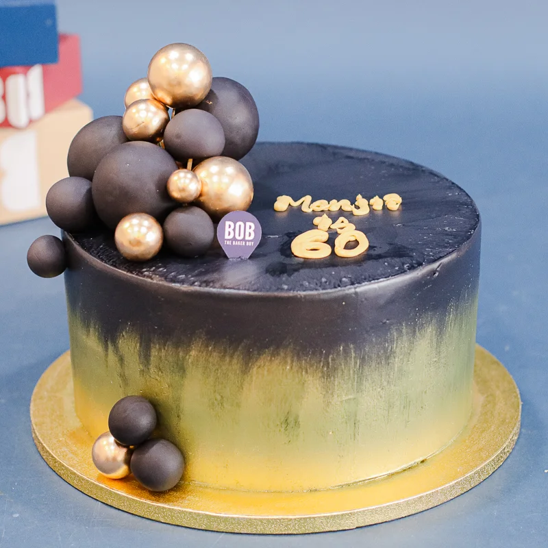 Extravagant Black and Gold Cake with Gold Ornaments
