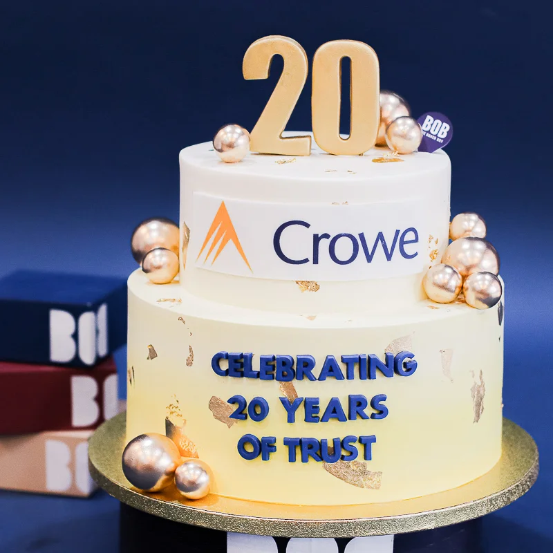 Lucky Yellow Corporate Cake with Gold Ornaments and Company Logo