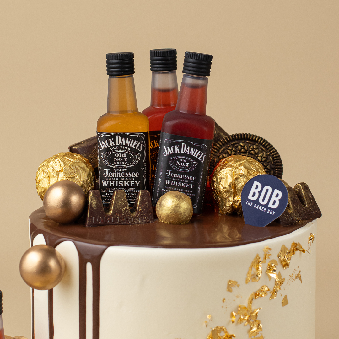 Whiskey Liquor Cake with Gold Ornaments and Drip